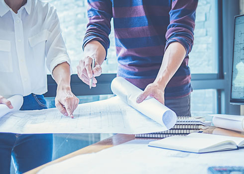 Technical documents being formatted at a desk